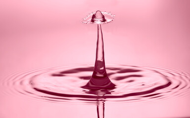 Water splash on surface created crown shape on pale lilac effect background. Environmental concern...