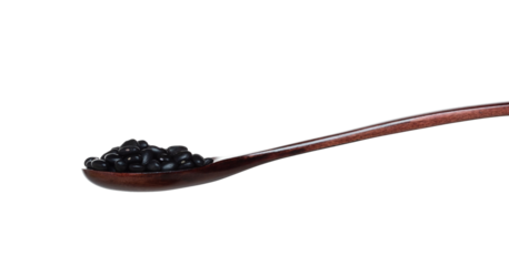 Black Bean fall, black grain beans explode abstract cloud fly from wooden spoon. Beautiful complete seed pea bean, food object design. Selective focus freeze shot white background isolated