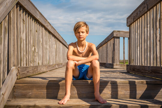 preteen boy nude Young Preteen Boy Sitting on Sunny Boardwalk by the Ocean Photos | Adobe  Stock