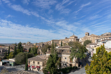 Fototapeta na wymiar Panoramic view of one of the parts of the city of Toledo where we can find very nice stone houses on a summer day with partly clear sky. Spain