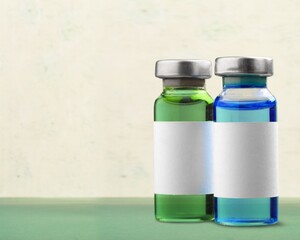 Vaccine medical bottle on desk in blur hospital