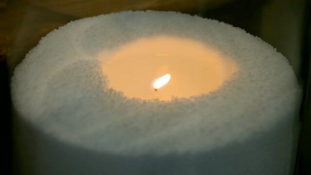 candle flame closeup burning on the white paraffin aka wax in the darkness, power outage, candlelight, combustion light diversity