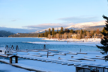 Snow covered Payette Lake and rugged mountains in McCall, Idaho, during wintery and festive Christmas season