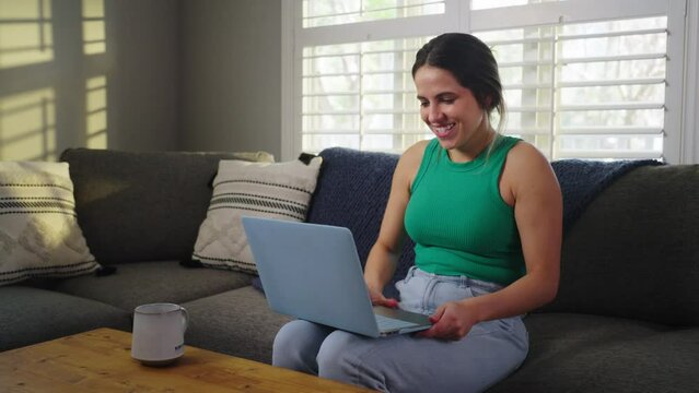 Beautiful female on computer finds a great website that is helpful.