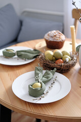 Festive Easter table setting with Easter bunny made of linen napkin and egg