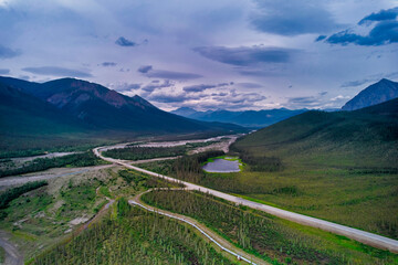 The Alaska Pipeline dips underground near Stevens Village Alaska as viewed from an aerial Drone on the Dalton Highway