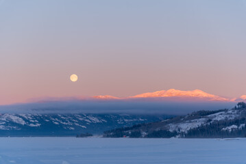Beautiful landscape views in northern Canada during winter time with pastel pink sky and moon...