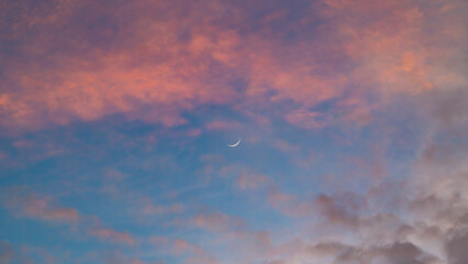 Sunset sky. Cirrocumulus and cirrostratus clouds during sunset. Beautiful dramatic sunset sky background. Selective focus included. Noisy photo.