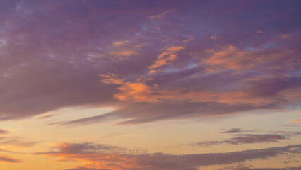 Sunset sky. Cirrocumulus and cirrostratus clouds during sunset. Beautiful dramatic sunset sky background. Selective focus included. Noisy photo.