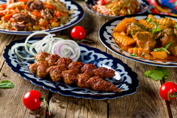 Lamb Lula kebab with red onion  on the board close up