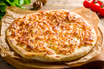 khachapuri with cheese, megrelian khachapuri, georgian cuisine on wooden table side view