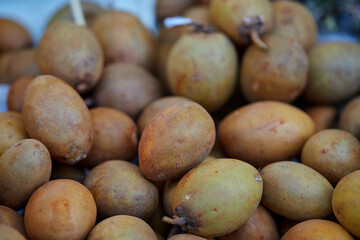 group of fresh Sapodilla or Ciku fruit for sale in market