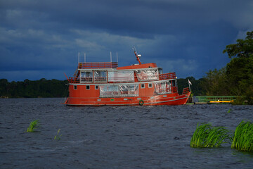 Typical Amazon boat on the Rio Negro in front of the Anavilhanas archipelago. Near Novo Airao,...