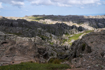 Panoramic view of the rock massif The Giants in Cordoba, Argentina. View of the cliffs and hills under a beautiful sky with clouds. 