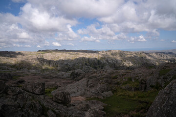 Panorama view of the rock massif The Giants in Cordoba, Argentina. View of the rocky hills and vast land under a beautiful sky with clouds.