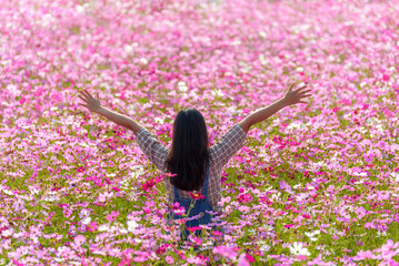 Happy woman raiseก open arms arms in flower garden, lifestyle and healthy confidence relax woman concept.