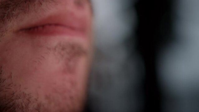Extreme Close-up of a Man Inhaling Cigarette Smoke and the Hazards of Smoking