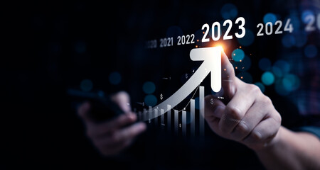 Business growing in 2023. Analytical businessman planning business growth 2023, strategy digital marketing, profit income, economy, stock market trends and business - obrazy, fototapety, plakaty