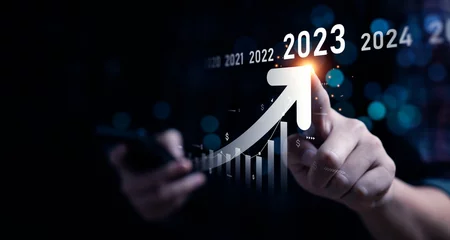 Fotobehang Business growing in 2023. Analytical businessman planning business growth 2023, strategy digital marketing, profit income, economy, stock market trends and business © Sutthiphong