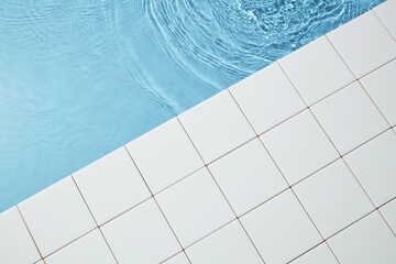 Summer and holiday concepts with blue water surface with ripples and mosaic background. Space for design, top view, flat lay.