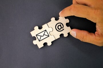 wooden puzzle with email icon and email address. Concept email address. Internet technologies and...
