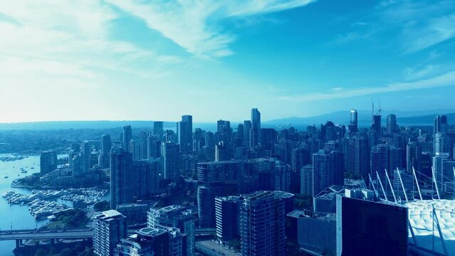 Vancouver Downtown Casino Stadium sunny summer day yachts docked Yaletown 4k Drone flyover modern architecture stunning new buildings overlooking birds top view calm water city traffic bridges parq