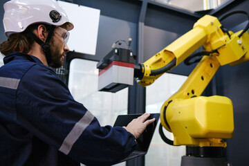 Engineer working in robotics factory