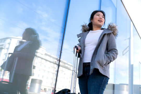 carefree asian traveller female woman casual cloth happiness lifestyle walking sight seeing on walkway footpath in Vienna Austria, asia woman traveller enjoy spending vacation time in Vienna Austria