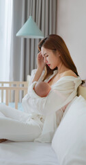 tired mother breastfeeding baby