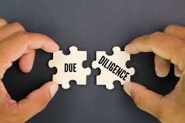 wooden puzzle with the word due diligence. the concept of self-integrity. the concept of...