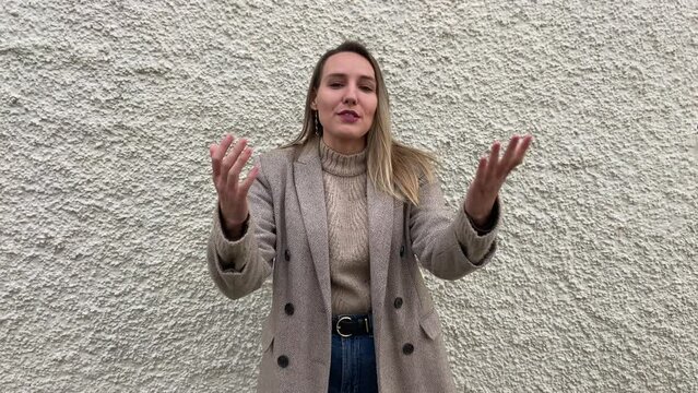 Young beautiful Spanish blonde woman in formal dress introducing herself and giving a formative speech. Mentor manager for corporation.