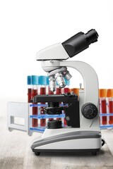 Modern microbiology microscope on table in laboratory.