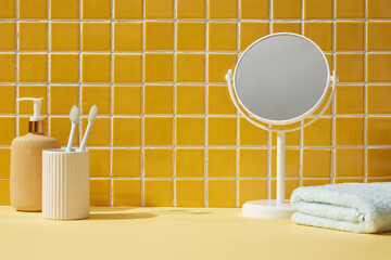 A mirror, towel and toothbrushes inside a bathroom background. Front view. Empty space for display cosmetic products - obrazy, fototapety, plakaty