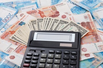 Economy financial concept, calculator on paper currency.