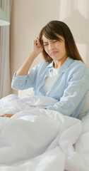 woman has headache on bed