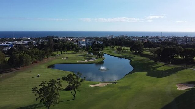 UHD golf course. Aerial images of a golf course in santo domingo, dominican republic. Cinematic aerial view on a sunny summer day. February 2023