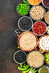 Legumes, beans and sprouts. Dried, raw and fresh, top view. Red kidney beans, lentils, mung beans, chickpeas, soybeans, edamame, green peas, Healthy, nutritious, diet food, vegan , micronutrients 