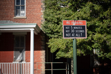 humorous no parking sign on the street