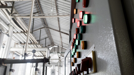 Close-up of lit  lights and Control Switch on a industrial control chiller with shiny lights .