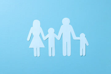 Family figure on blue background. Family insurance and medical care concept. 