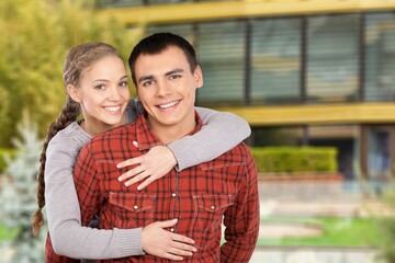 Loving happy young couple walk on street