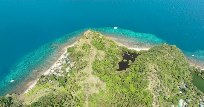 Coast with beach and coral reef in the tropics. Apo Island. Negros, Philippines.