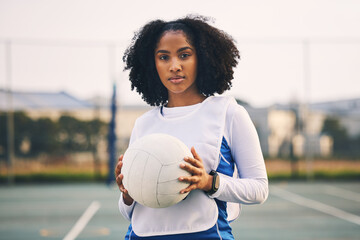 Sports, netball and portrait of a woman with a ball after a match, exercise or training on the court. Confidence, fitness and female captain athlete standing on field after game, workout or practice. - Powered by Adobe