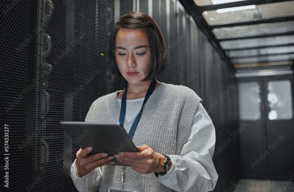 Poster Tablet, server room and security with a programmer asian woman at work on a computer mainframe. Software, database and information technology with a female coder working alone on a cyber network