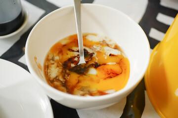two Fried eggs in a bowl on table 