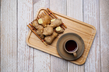 Ginger tea on wooden background.