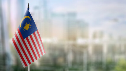 Small flags of the Malaysia on an abstract blurry background