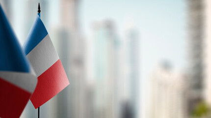 Small flags of the France on an abstract blurry background