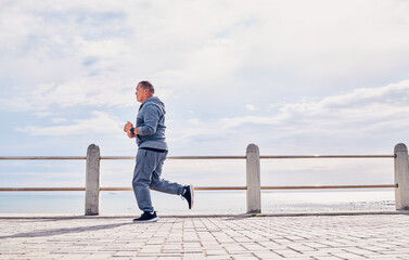 Senior man, sports and running at beach promenade with sky mockup for energy, body wellness and...
