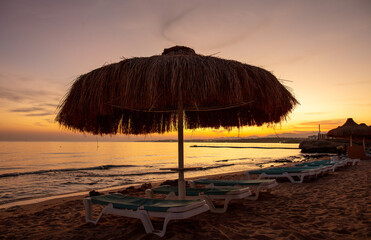 Sun lounger on the beach at sunset.